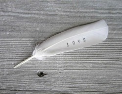 Feather with the word love on it